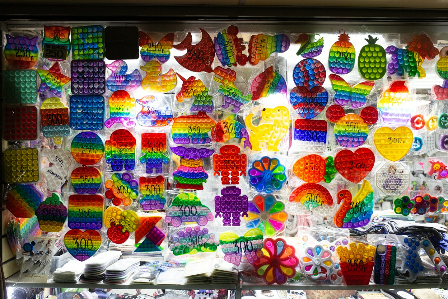 Retail display case filled with colorful pop-it fidget toys.
